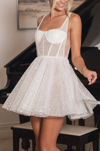 Close up image of ivory white beaded tulle bridal mini dress with sheer corset bodice and flared mini skirt