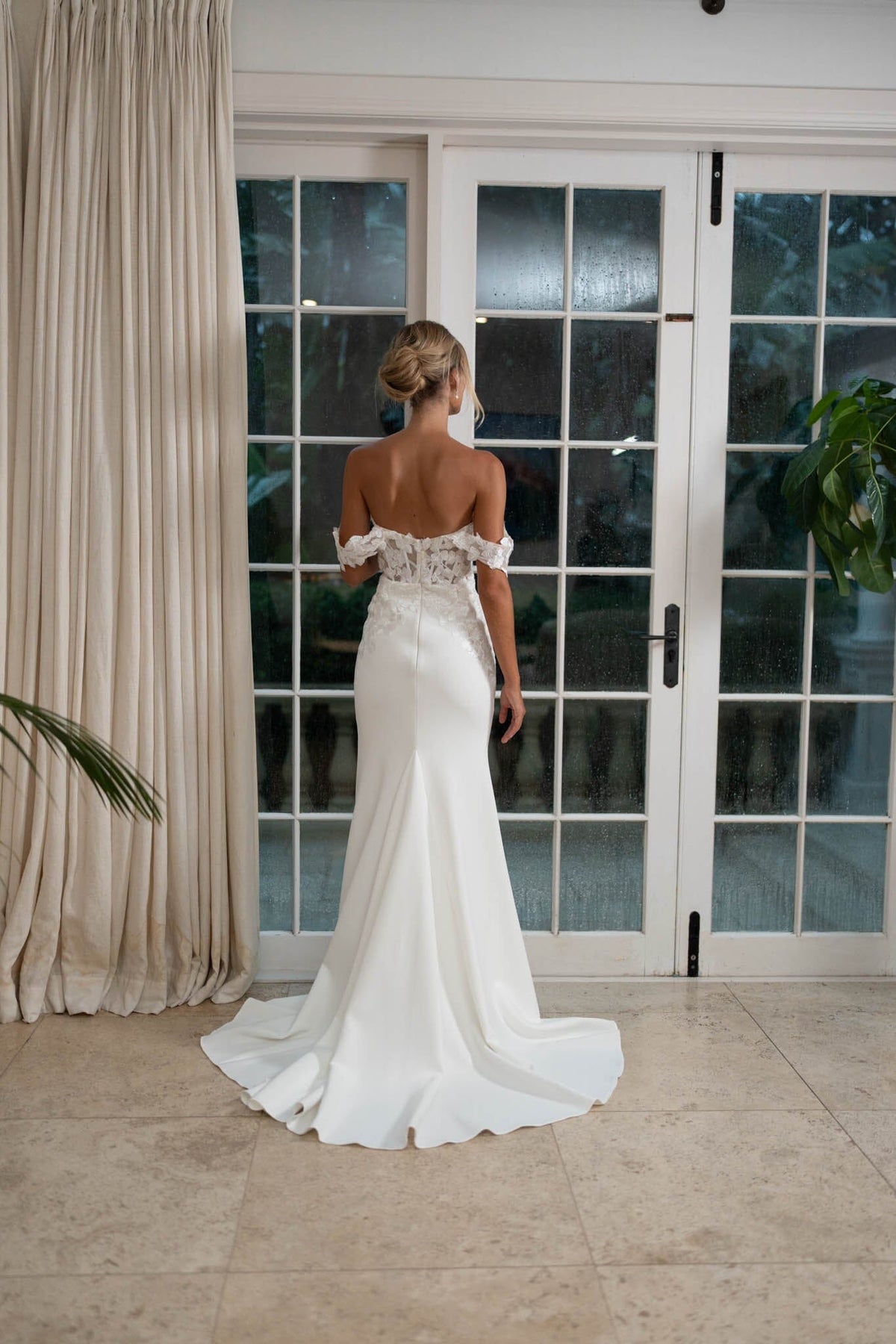 Back image of White Off The Shoulder Fitted Wedding Gown with Semi Sheer Corset Style Bodice and moderate train