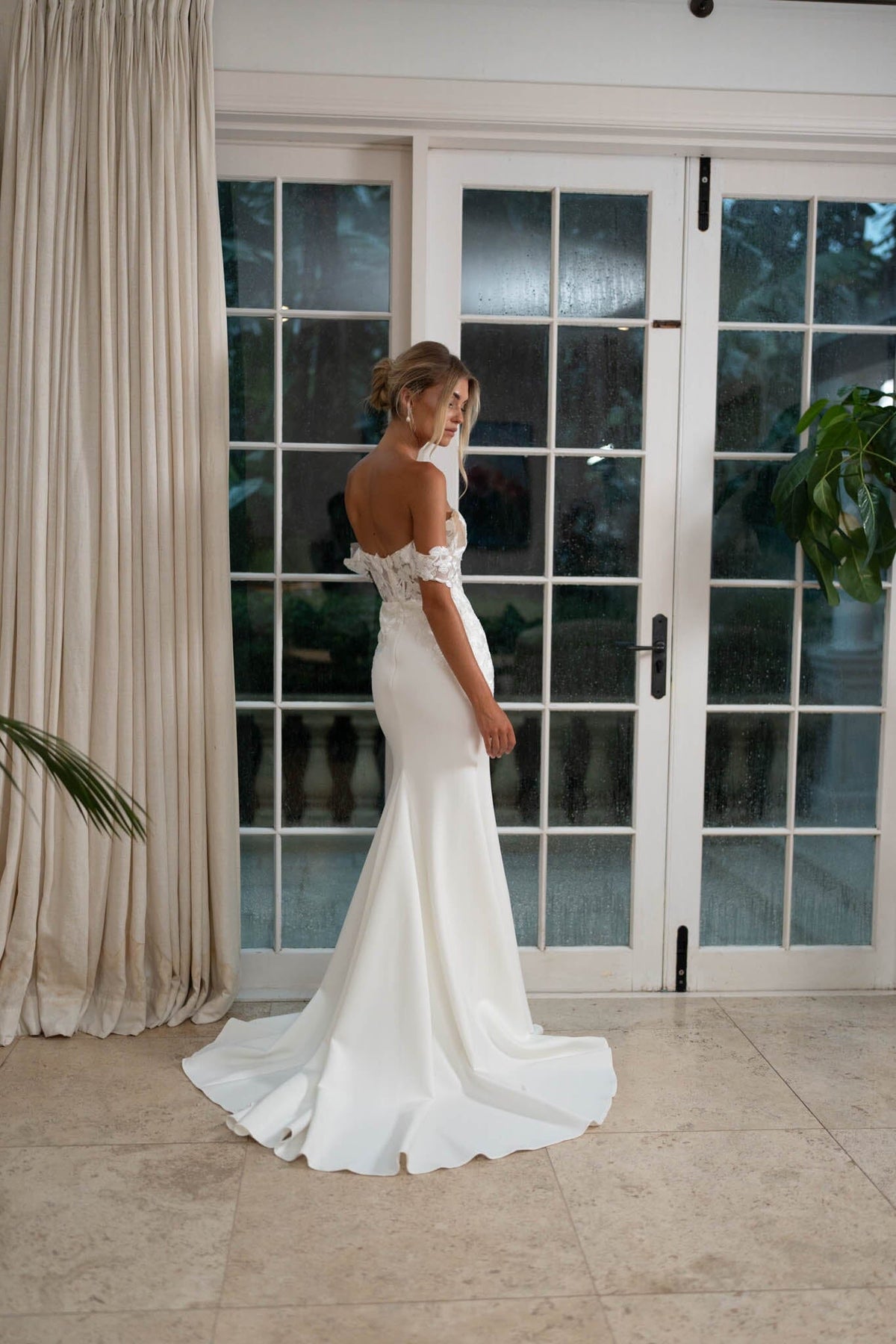 Back image of White Off The Shoulder Wedding Gown with Semi Sheer Corset Style Bodice, Sweetheart Off Shoulder Neckline, Lace Appliques, Fit and Flare Silhouette and Moderate Train